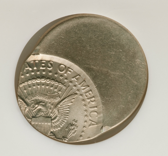 2008 Kennedy half dollar off-center strike error showing partial design and blank planchet crescent